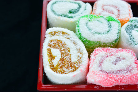 Delicious colorful rolls of Lokum with fruit marmalade jam in japanese style in japanese lacquer...