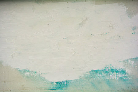 White rough concrete wall with blue and white paint. Painted old urban wall