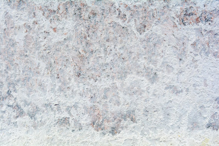 Texture of polished granite floor with white dense mud like chalk or lime. Rough stone wallpaper....