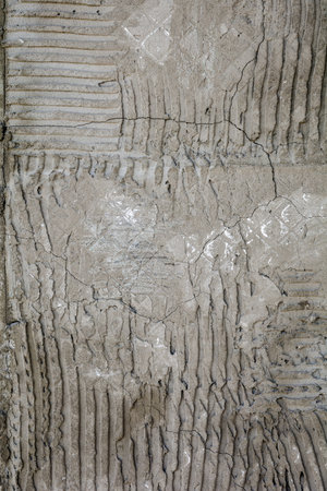 Rusty concrete surface with striped relief. Texture with engraved lines on urban cement wall. Txture...