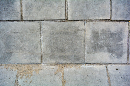 Large square cement street floor slabs. Texture of gray dirty tiles pavement. City outside plaster floorの写真素材