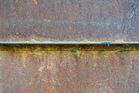 Detail of rusty corroded metal flat shutter or door. Old red metal texture background