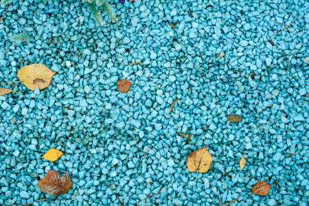 Blue marble fine gravel. Simple stone background with blue pebbles. Stone texture. Top view of ground decor for garden with colorful natural stoneの写真素材