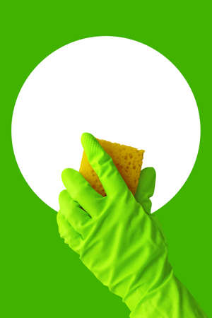Human hand with green rubber gloves holding yellow sponge. Concept of sanitation and hygiene with copy space for text. Isolated hand with latex gloveの写真素材