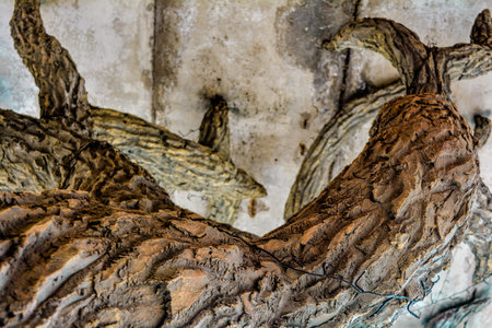 Clumsy artificial tree supports roof like decorative pillar. Architectural column in form of artificial tree sculptureの写真素材