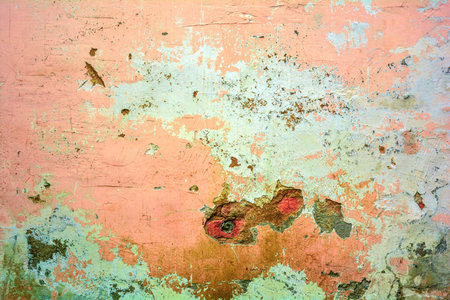 Old grunge messy plaster wall with peels of paint. Rough urban concrete wall texture with damages