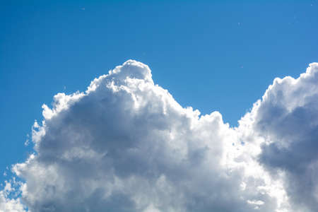Blue sky background and fluffy white large cloud in sunny dayの写真素材