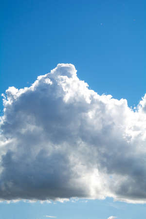 Blue sky background and fluffy white large cloud in sunny dayの写真素材