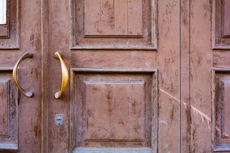 Old wooden exterior door. Antique weathered door close-upの写真素材