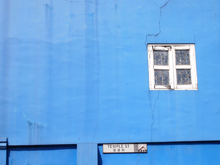 Blue wall with white window frameの写真素材