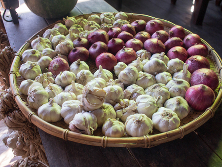Onions and garlic in basket.の写真素材