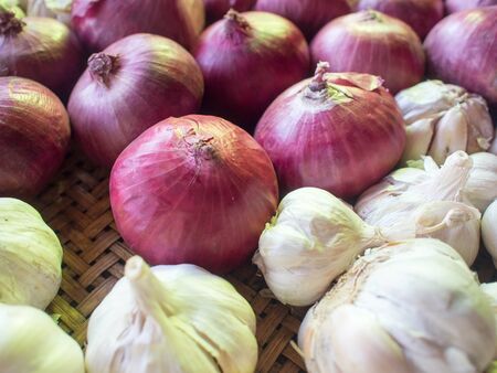 Onions and garlic in basket.の写真素材