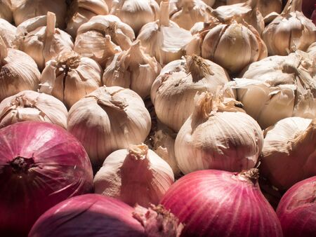 Onions and garlic in basket.の写真素材