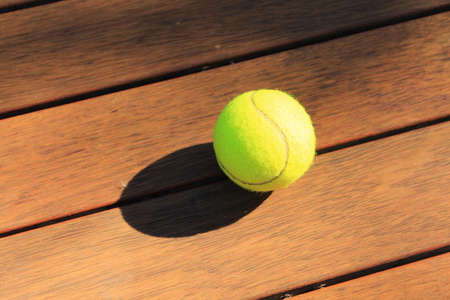 tennis ball on wooden floorの写真素材