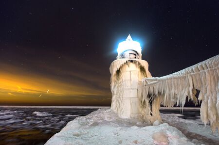 Frozen St. Joseph Lighthouse at night in St. Joseph Michigan.の写真素材