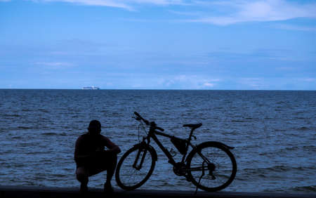 Silhouette the cyclist and his bicycleの写真素材