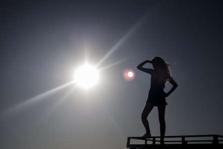 Silhuette of girl in the sunの写真素材