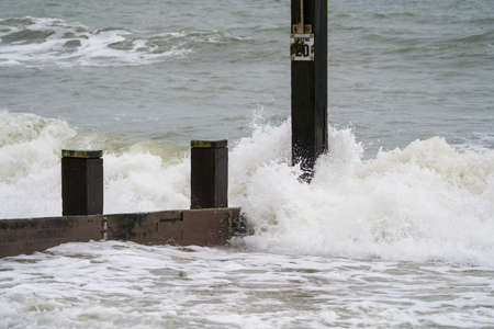 Stormy sea waves breaking on a pier. Stormy weather.の写真素材