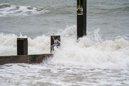 Sea waves breaking on the pier. Sea storm. Stormy weather.の写真素材