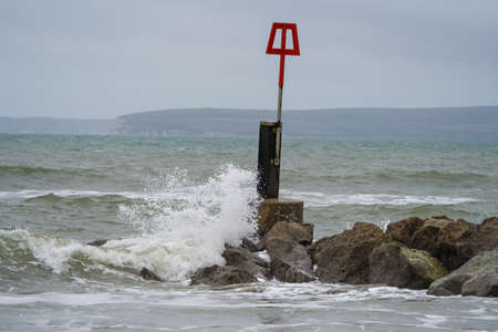 A red warning sign on a breakwater on the Baltic Sea coastの写真素材