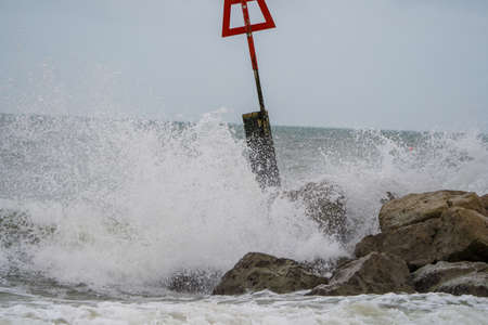 Waves breaking on the rocks on a stormy day in Malaga, Spainの写真素材