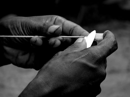 Primitive hands making a dartの写真素材