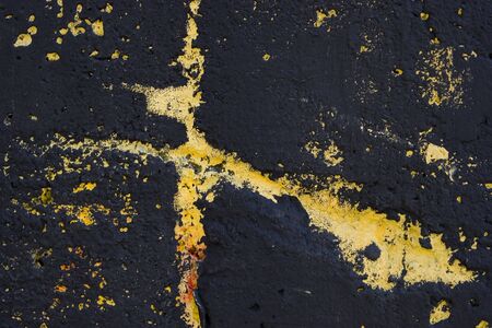 old wall background painted black and yellowの写真素材