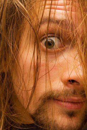 creepy looking young man with log hairの写真素材