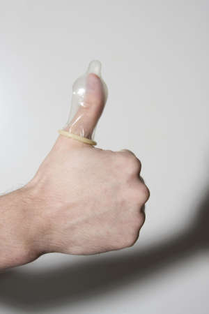 thumbs up, condom on thumbの写真素材