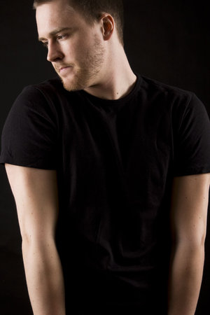 young man portrait on black backgroundの写真素材