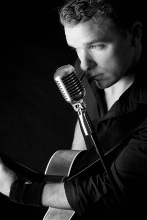 young musician playing a guitar and singingの写真素材