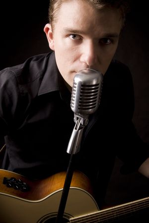 young musician playing a guitar and singingの写真素材