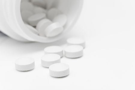 Spilled pills from open prescription medication bottleの写真素材