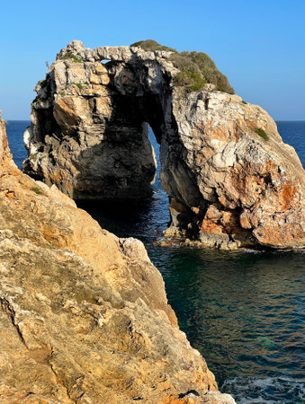 Beautiful view on natural rock arch (13 meters high) at viewpoint, Mirador Es Pontas on Mallorca island, SantanyÃ­, Balearic islands, Spainの写真素材