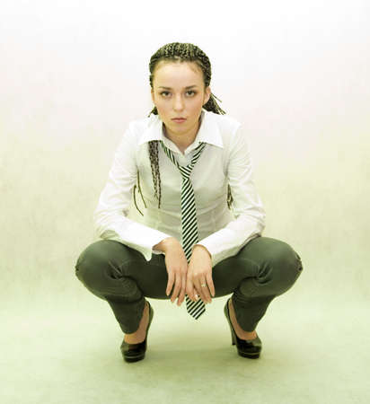 beauty girl in shirt with striped tie on a white backgroundの写真素材