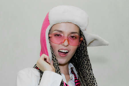 beauty girl in fur cap with ear flaps on a white backgroundの写真素材