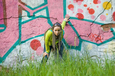 beauty girl on a graffiti wall backgroundの写真素材
