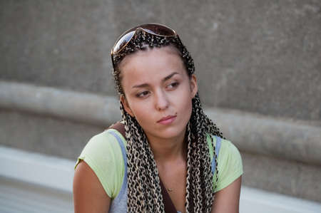 portrait of beautiful girl on gray wall backgroundの写真素材