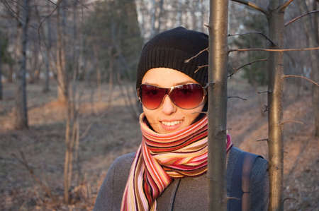 beauty smiling girl in striped scarf on nature backgroundの写真素材