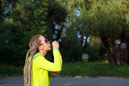 beauty girl belly soap bubbles on nature background