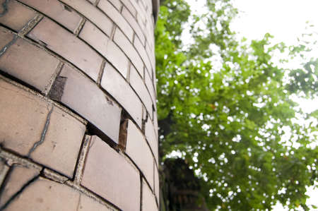 old column with cracks on green tree backgroundの写真素材