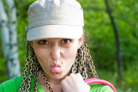 beauty girl put out one's tongue on the nature backgroundの写真素材