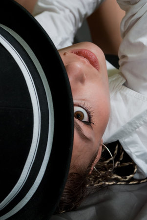 beauty sexy girl in black hat and white shirt on the gray material