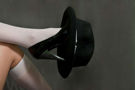 black hat to shoe with heel on gray backgroundの写真素材