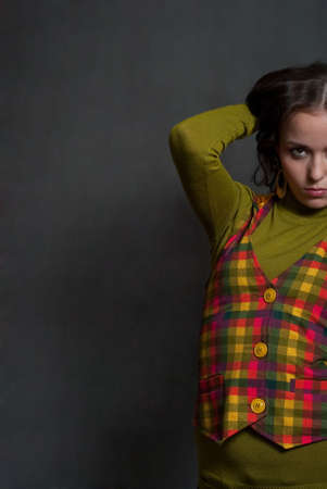 beauty girl in  squared waistcoat on the gray backgroundの写真素材