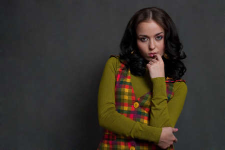 beauty girl in  squared waistcoat on the gray backgroundの写真素材