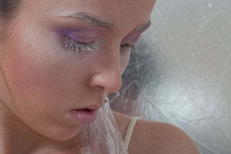 beauty young girl on the silver backgroundの写真素材