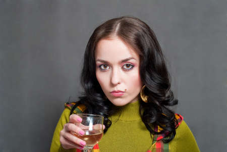 beauty girl with wine in  squared waistcoat on the gray backgroundの写真素材