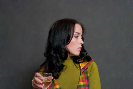 beauty girl with wine in  squared waistcoat on the gray backgroundの写真素材