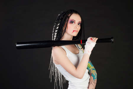 beauty girl with bat and with body art on her hand isolated on black backgroundの写真素材